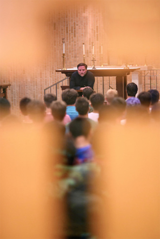 Fr. Chris delivers a speech on faith and dorm life to new freshman in the Stanford Hall chapel